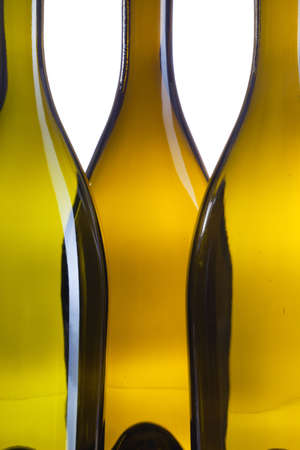 Detail of three empty wine bottles on a white backgroundの写真素材