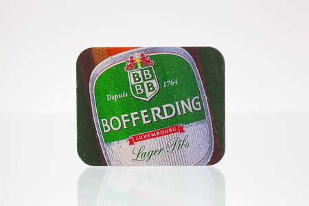 Germany,Berlin - January 7,2015:Beermat from Bofferding beer on a glass table.Brasserie Nationale is the largest brewery in Luxembourg, based in Bascharage.のeditorial素材