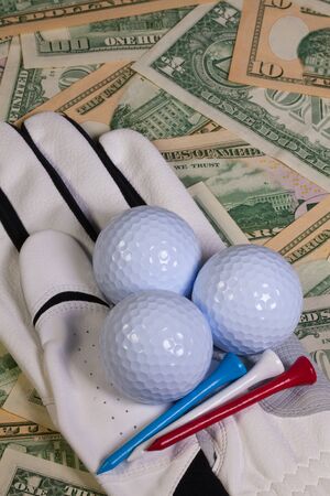 Golf equipments and US dollar banknotesの写真素材