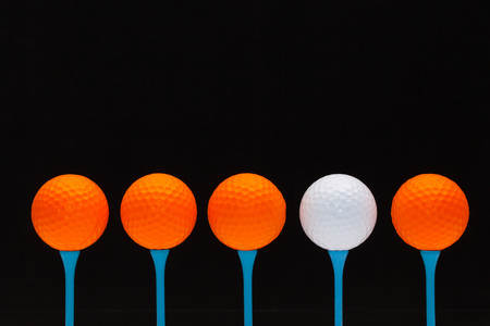 Golf balls on blue wooden teesの写真素材