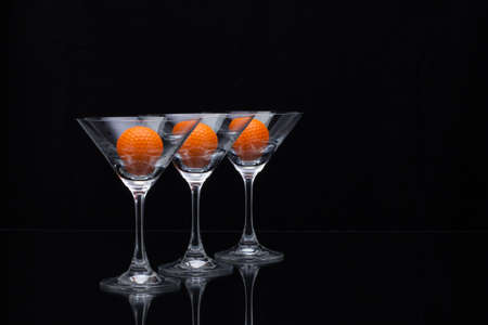Three glasses of champagne with golf ballsの写真素材