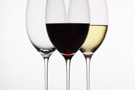 Wineglass with red  and white wine on a white backgroundの写真素材