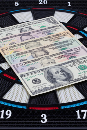 Detail dartboard with US dollar banknotesの写真素材