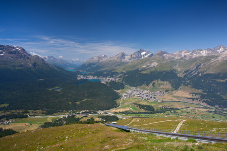 Panorama of the Upper Engadine from Muottas Muragl with very steep trail