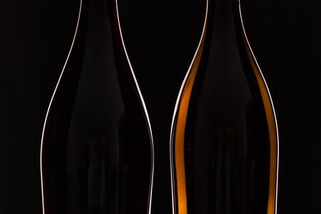 Two different bottles of wine on the black backgroundの写真素材