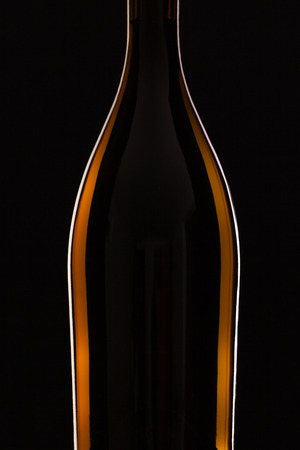 Detail of bottle with red wine on the black backgroundの写真素材