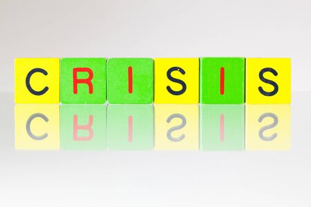 Crisis - an inscription from children's wooden blocksの写真素材