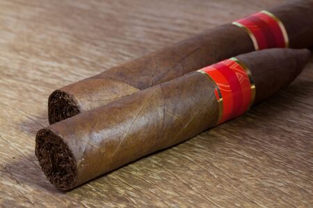 Different cigars on the very old wooden tableの写真素材