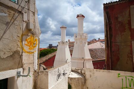 Typical street with old and unrepaired homes in central Lisbon, Portugalの写真素材