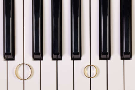 Detail of piano keyboard and wedding ringsの写真素材