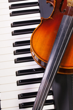 Detail of piano keyboard and old violinの写真素材