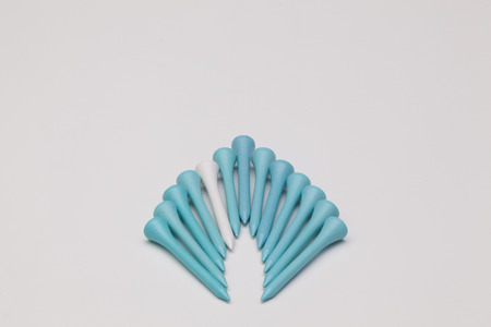 Wooden golf tees on the white backgroundの写真素材