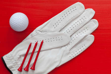 Golf equipments on the wooden red tableの写真素材