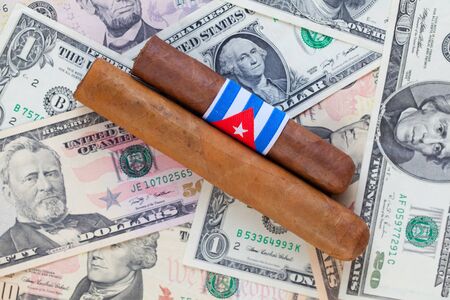 Detail of luxury Cuban cigars on the US dollar banknotesの写真素材