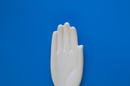 Detail of ceramic hand on the blue wooden desk - Flat Lay Photographyの写真素材