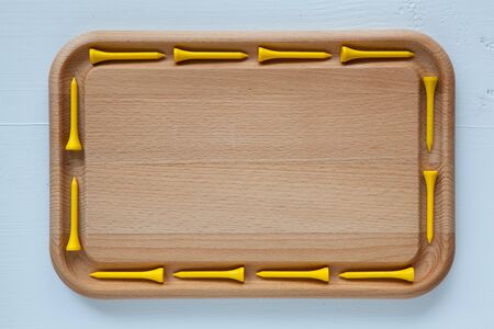 Empty cutting board with different wooden golf teesの写真素材