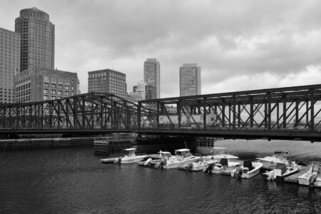 Boston skyline and Northern Avenue Bridge. Built in 1908, it was closed to vehicle traffic in 1999 - Black and White Photoの写真素材