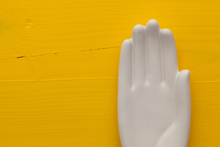 Detail of artifical hand on the wooden deskの写真素材