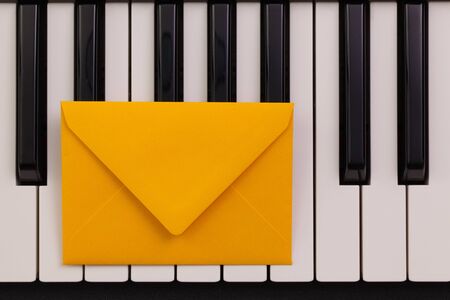 Funny arrangement envelope on the piano keybords - Flat lay image
