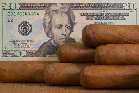 Luxury Cuban cigars with US dollar banknote on the wooden table.の写真素材