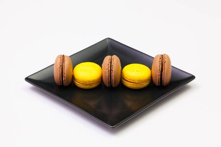 Traditional french colorful macarons on the black plateの写真素材