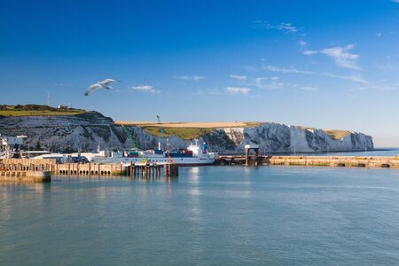 Dover,England-July 9,2013: White cliffs and Dover harbor along the coast of English channel.The Port of Dover is the nearest English port to France, at just 34 kilometres (21 mi) away.のeditorial素材