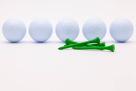 White golf balls and wooden tees on the white background.Golf concept.の写真素材