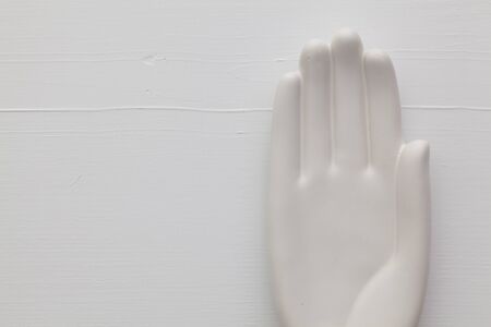 Detail of artifical hand on the wooden desk