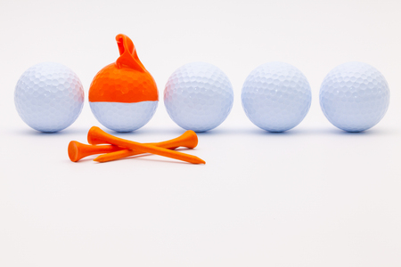 White golf balls with funny cap on the white background. Funny golf concept.の写真素材