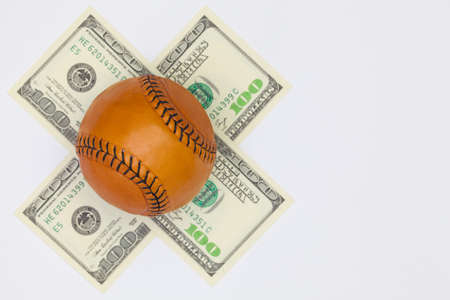 Leather baseball ball and us dollar banknotes on the white table. Flat lay photographyの写真素材
