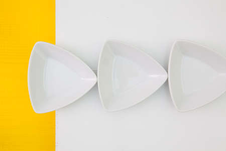 Ceramic bowls for sushi food on the yellow  and white wooden table