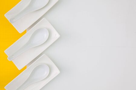 Ceramic bowls for sushi food on the yellow  and white wooden table