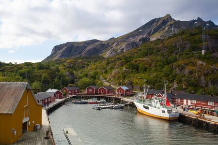 Nusfjord, Norway - August 21,2017: Red Classic Norwegian Rorbu fishing huts, Nusfjord on Lofoten islands. Norwegian traditional type of house used by fishermenのeditorial素材