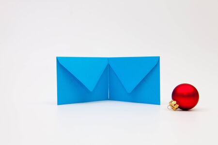Blue envelopes and Christmas decoration on the white tableの写真素材