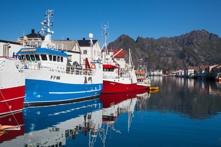 Henningsvaer, Norway - August 19,2017: Picturesque fishing port in Henningsvaer on Lofoten islands, Norway with typical red wooden buildings and small fishing boatsのeditorial素材