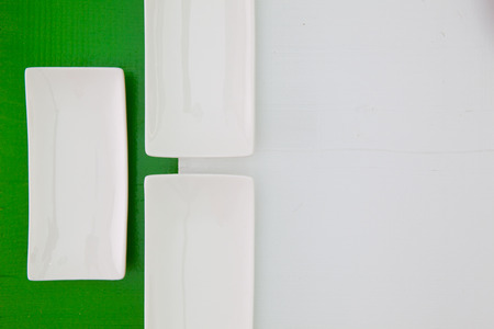 Ceramic bowls for sushi food on the green and white wooden tableの写真素材