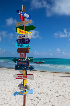 Playa del Carmen, Mexico - February 5, 2018: Funny direction signpost with distance to many different countries on Mexican coastline. This resort area is popular destination with the most beautiful beaches.のeditorial素材