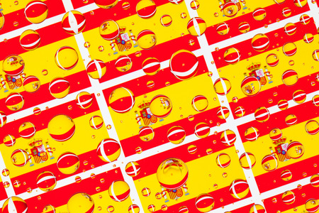 Flags  of Spain, behind a glass covered with rain drops.Pattern from Spanish flags