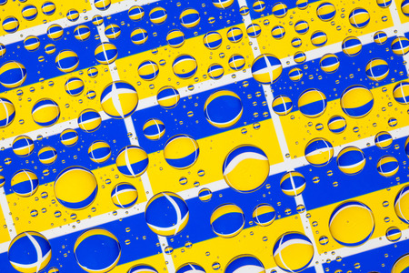 Flags  of Ukraine, behind a glass covered with rain drops.Pattern from flags of Ukraineの写真素材