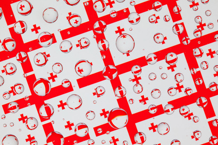 Flags  of Georgia, behind a glass covered with rain drops.Pattern from Georgia flags.  3D...