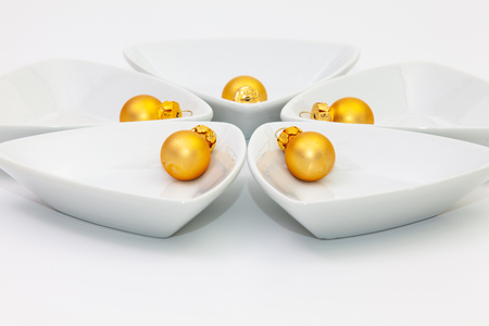 Ceramic bowls for sushi food and gold Christmas decoration on the white tableの写真素材