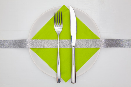 White square plate and green Christmas decoration on the white  wooden table.Top view.Flat Lay Image.の写真素材