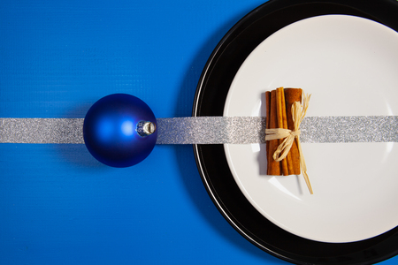 Black and white plates and Christmas decoration on the blue wooden table.Top view.Flat Lay Image.の写真素材