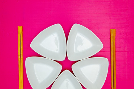 Ceramic bowls  and bamboo chopsticks for sushi food with on the pink wooden table.Top view. Flat Lay Image.の写真素材