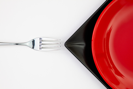 Different  red and black plates on the white table.Top view. Flat Lay Image.の写真素材
