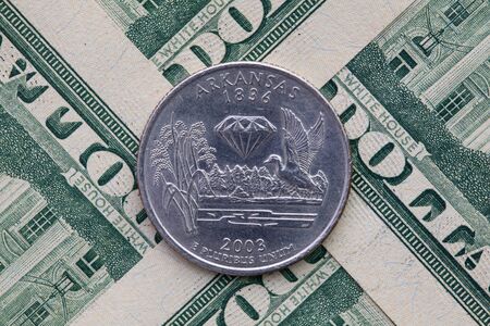 A quarter of Arkansas on US dollar bills. Symmetric composition of US dollar bills and a quarter of...