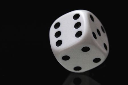 White dice on the black background. Playing dice at black  background. Playing a game with dice....
