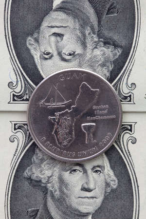 A quarter of Guam on US dollar bills. Symmetric composition of US dollar bills and a quarter of Guamの写真素材