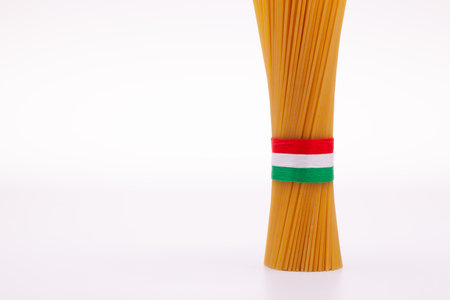 Bundle of spaghetti and Italian flag on the white background.の写真素材