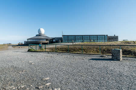 A view of Nordkapp Visitors Centre taken from the monument under a clear blue sky.の写真素材